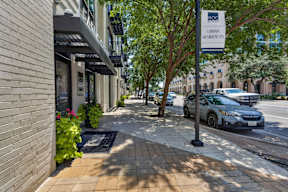 A street view of a building with a sign that reads "Urban Residences".