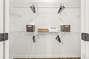 Empty white refrigerator with two baskets on the shelves.