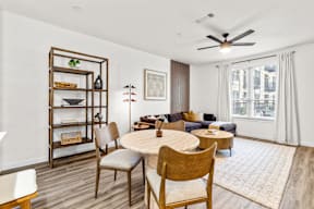 A living room with a round table and chairs.