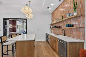 A kitchen with a wooden counter and a white dining table.