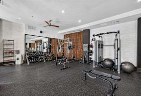 A spacious home gym with a variety of exercise equipment.