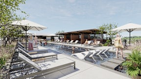 A poolside scene with people relaxing and a building in the background.
