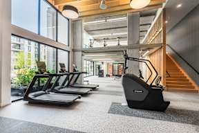 A gym with treadmills and a staircase.