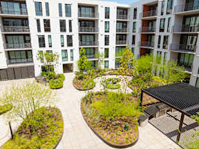 A modern apartment complex with courtyards and trees.