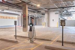 An electric vehicle charging station in a parking garage.