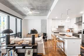 A modern kitchen with white cabinets and a large island.