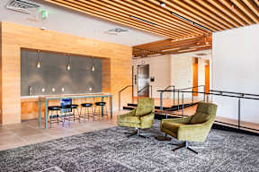 A room with a bar and chairs.