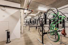 A bike rack with multiple bicycles parked inside a building.
