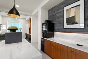 a kitchen with a marble counter top and a black tv