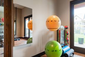 A room with a green ball and a mirror on the wall.