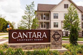 A sign for Cantara Apartment Homes in front of a building.