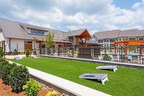 A modern building with a pool in the backyard.