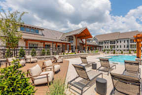A large building with a pool in front of it.