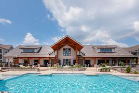 A large house with a pool in front.