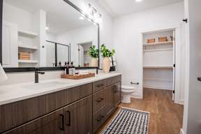 A bathroom with a sink, mirror, and toilet.