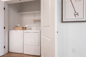 A small laundry room with a washer and dryer.