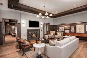 A modern living room with a fireplace and a television.