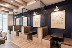 A room with a blue wall and a framed drawing on the wall.