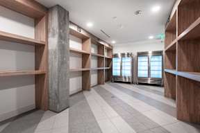 A room with wooden shelves and a marble column.