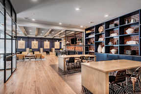A modern dining room with wooden floors and furniture.