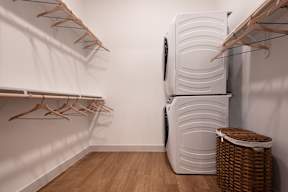 A white refrigerator with a basket underneath it.