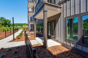 A modern building with a balcony and a metal railing.