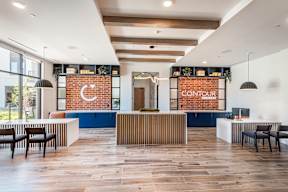 A modern office space with a reception desk and seating area.
