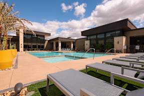 A modern building with a pool in front.