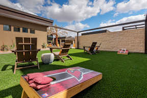 A backyard with a table and chairs and a slide.