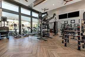 A spacious home gym with a variety of exercise equipment.