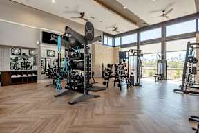 A gym with a variety of equipment including weights and machines.