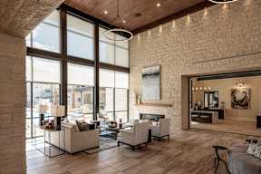 A modern living room with a fireplace and a large window.