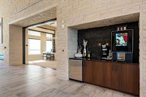 A modern kitchen with a TV on the counter.