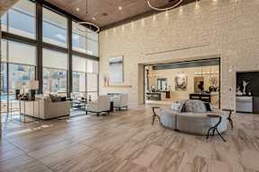 A modern living room with a large window and a couch.