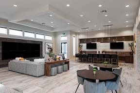 A modern living room with a fireplace and a dining area.