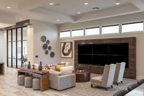 A modern living room with a fireplace and a large painting on the wall.