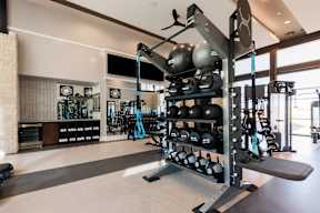 A gym with a variety of equipment including weights and resistance bands.