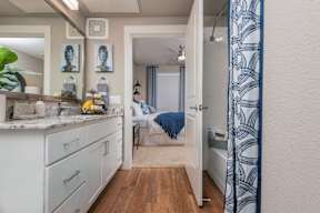 A bathroom with a white shower curtain.