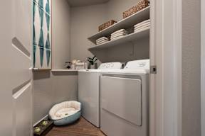 A small laundry room with a washer and dryer.