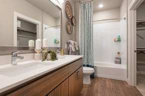 A bathroom with a white sink and a white toilet.