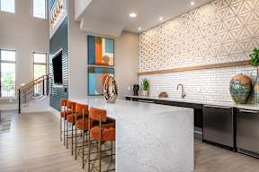 Community lounge with bar seating and modern design at Finley on the Green.