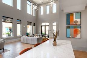 Spacious community room with TV and open kitchen at Finley on the Green.