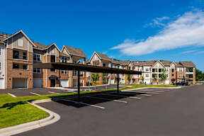 A row of modern apartment buildings with a clear blue sky above.