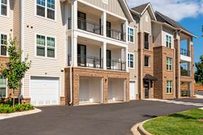 A large apartment complex with multiple balconies and garages.
