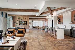 A modern kitchen with a dining area and a living room.