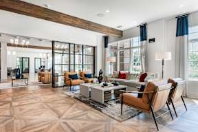 A living room with a wooden floor and a large window.