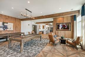 A room with a pool table and a painting on the wall.