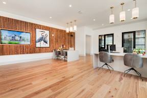 A room with wooden floors and a painting of a bird on the wall.