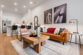 A modern living room with a wooden coffee table and a couch.