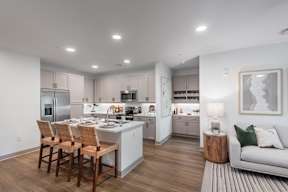 A modern kitchen with a dining table and chairs.